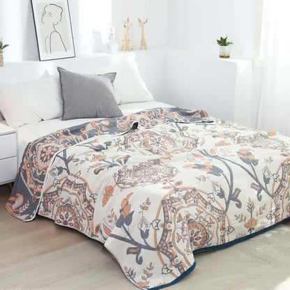 A soft cream-colored decorbites boho mandala cotton summer blanket with terracotta navy and muted gold floral patterns