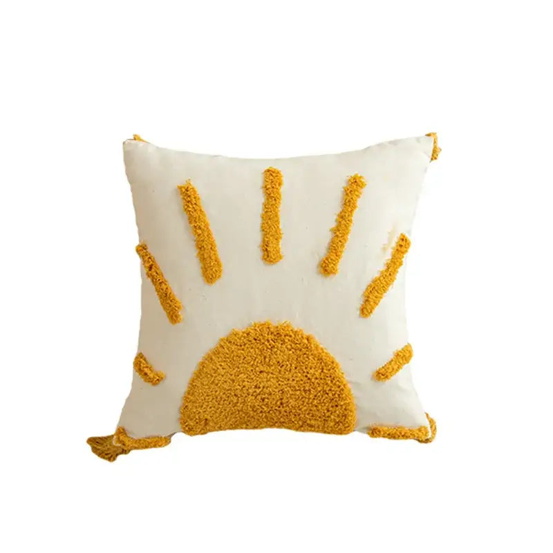 Cream-colored cushion cover with textured mustard-yellow geometric tufted embroidered sun design and pom pom trim decorbites
