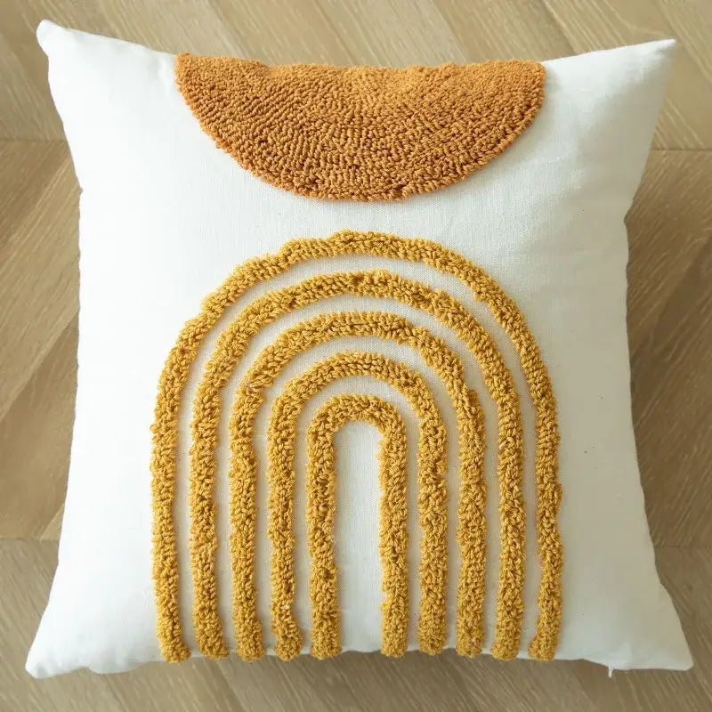 White cushion cover with textured mustard yellow geometric tufted embroidered rainbow and pom pom decorbites design