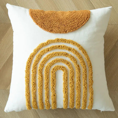 White cushion cover with textured mustard yellow geometric tufted embroidered rainbow and pom pom decorbites design