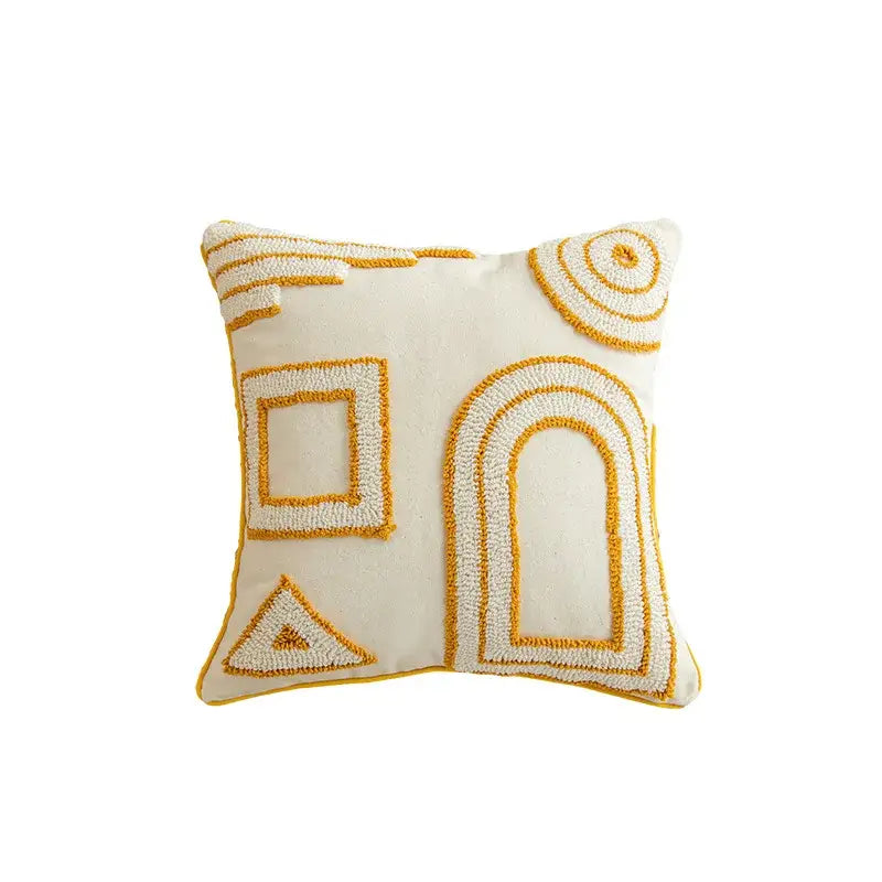 Cream-colored cushion cover with mustard geometric tufted embroidered design and pom pom accents for living room decorbites