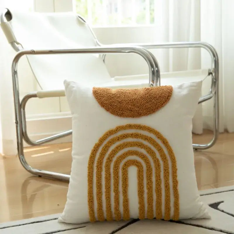White cushion cover with mustard yellow geometric tufted embroidered rainbow and pom pom decorbites living room accent