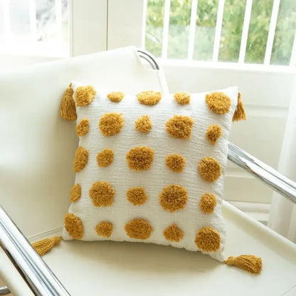 White cushion cover with mustard-yellow pom-poms and tassels featuring decorbites geometric tufted embroidery for living room decor