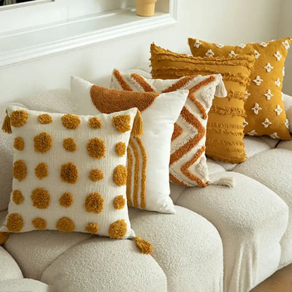Cream-colored cushion cover with mustard pom-poms and textured cotton fabric for decorbites geometric tufted decor