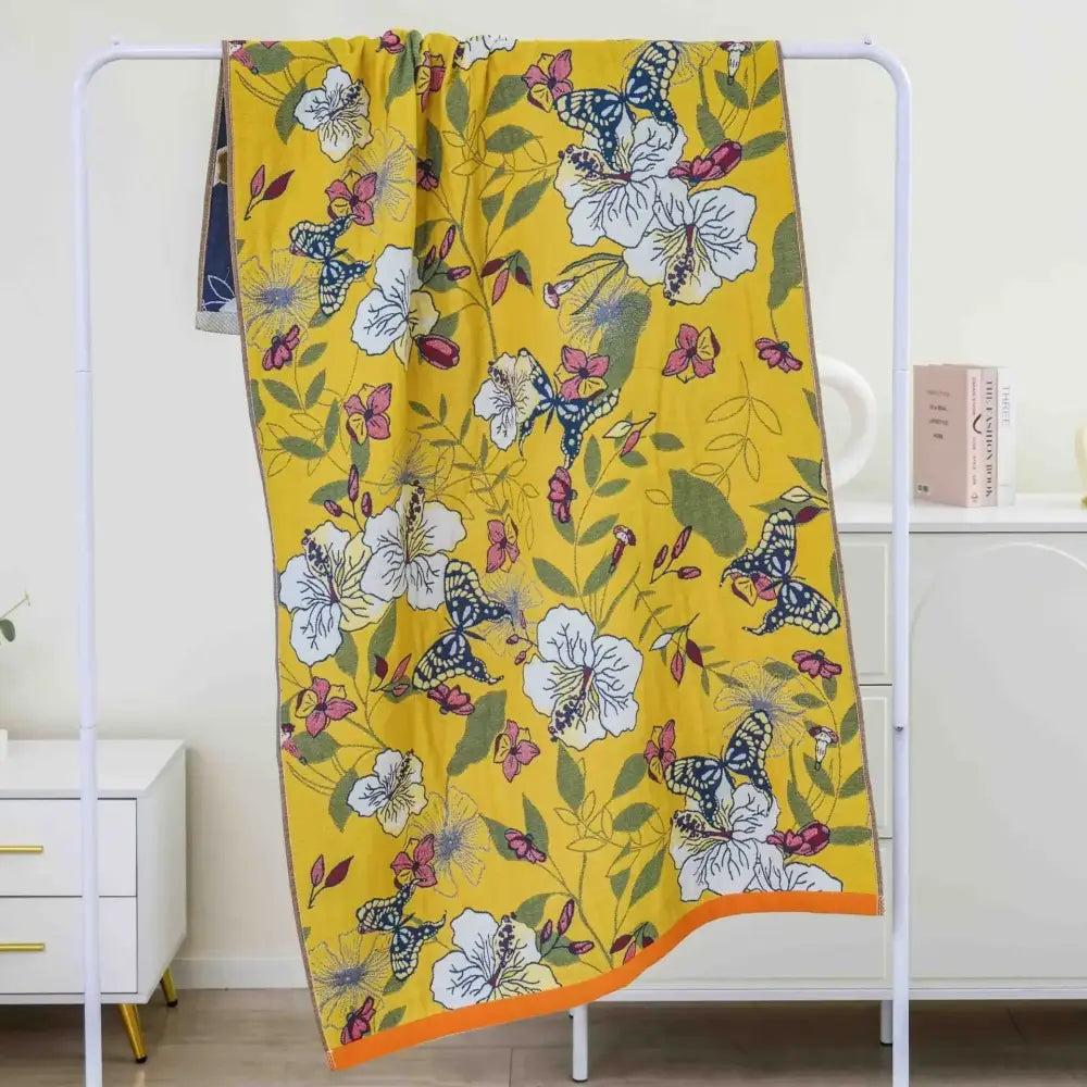 Boho navy and yellow cotton bath towel with vibrant butterfly pattern and orange border for bathroom decor