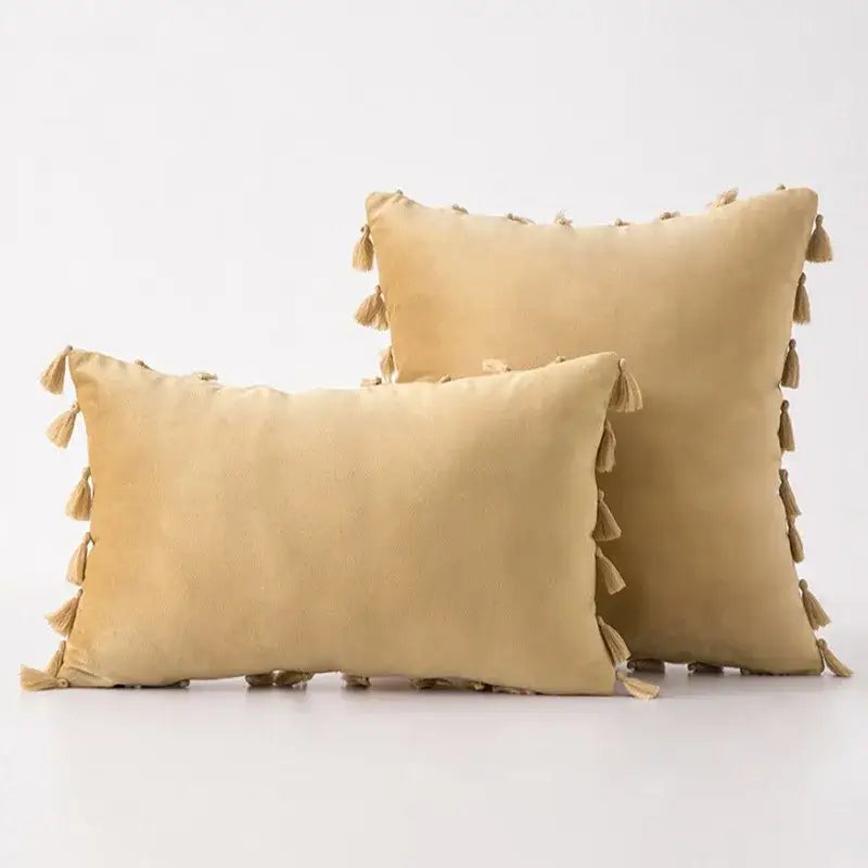 Beige suede throw pillow covers with tassel fringe perfect for boho home decor and living room accents