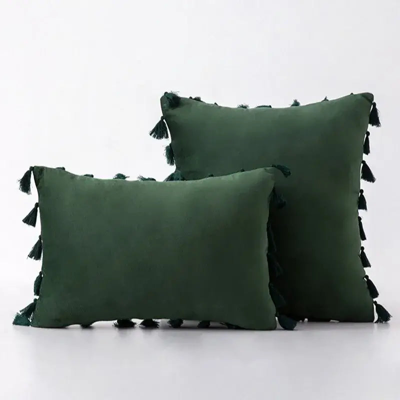 Dark green velvet pillow covers with black tassel fringe edges for stylish boho home decor living room accents
