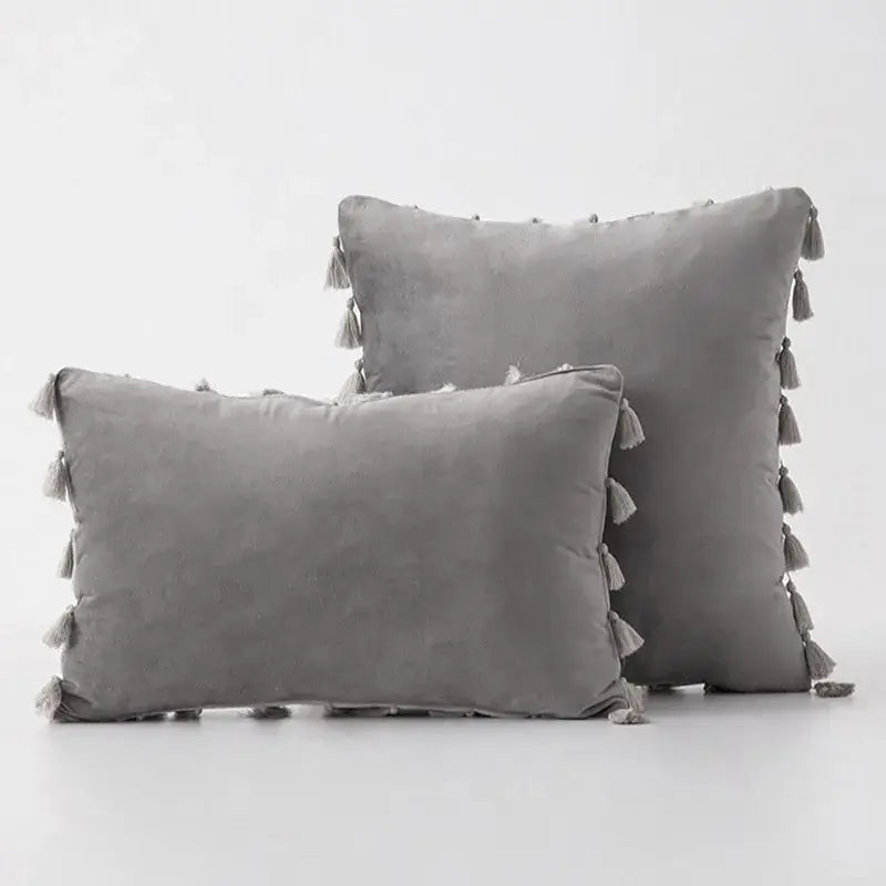 Gray velvet pillow covers with matching tassel fringe edges for boho home decor and living room style