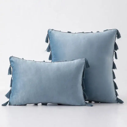 Soft blue velvet pillow covers with tassel fringe edges ideal for boho home decor and living room accents