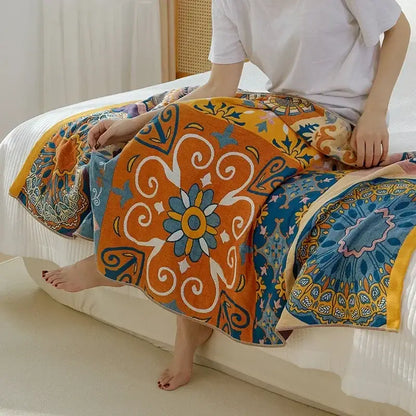 Vibrant orange and blue cotton gauze bath towel with intricate floral swirl design for boho bathroom decorbites cotton gauze