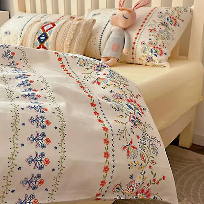 White duvet cover with intricate embroidered floral patterns in red blue and green from decorbites boho pattern printed bedding set