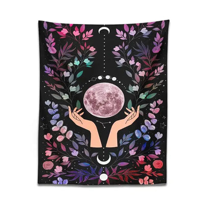 A black boho pink botanical moon tapestry featuring a pink moon held by hands with floral and celestial motifs