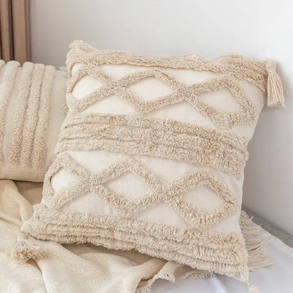 Cream-colored decorbites boho square pillowcase with textured fringed zigzag patterns and teal tassels for living room decor
