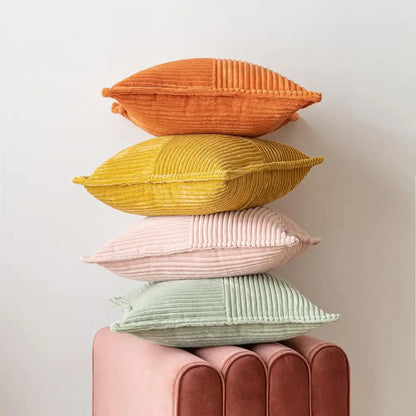 Stack of four colorful corduroy pillow covers in orange yellow pink and mint green for boho striped pillow decor
