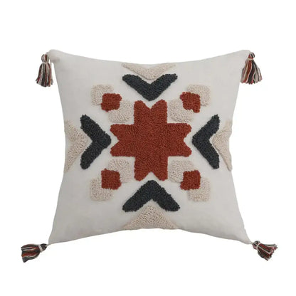 Cream-colored pillow cover with boho style embroidered rust geometric pattern and multicolored tassels decorbites boho style