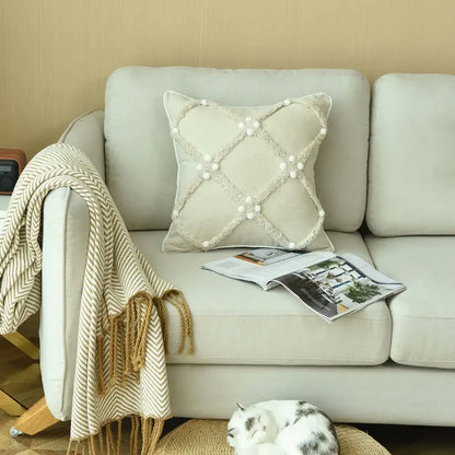 Beige boho style ivory cushion cover with textured crosshatch pattern and white pom pom accents for decorbites decor
