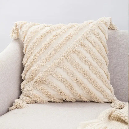 Cream-colored boho tufted beige pillow cover with textured diagonal ribbing and tassels for living room decorbites decor
