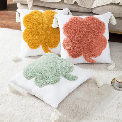 Three cozy throw pillows with plush shamrock design in mustard yellow coral pink and mint green on white cushion cover decorbites boho tufted embroidered