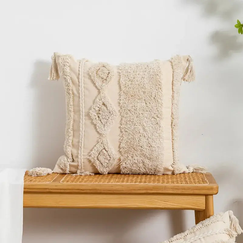 Cream-colored boho tufted embroidered cushion cover with textured woven patterns and tassels for living room decorbites decor
