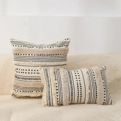 Cream-colored boho tufted fringed black and white throw pillows with geometric patterns for living room decorbites decor