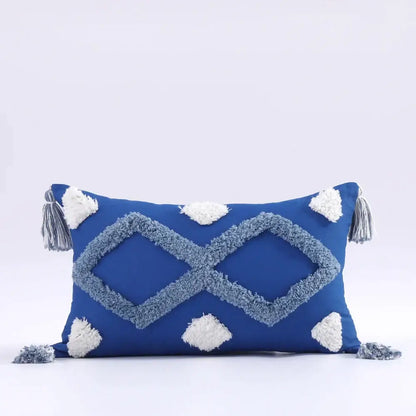 Vibrant blue boho tufted tassel cushion cover with light gray geometric pattern and white pom-poms for living room decor