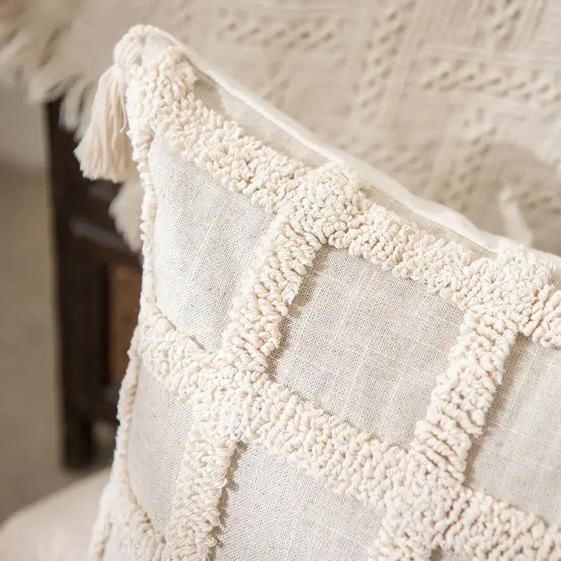 Cream-colored boho tufted tassel cushion cover with textured woven grid pattern for living room decor
