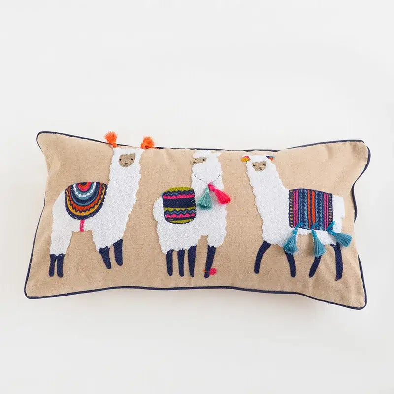 Beige rectangular decorbites boho vintage embroidered pillow featuring three white llamas with colorful blankets and tassels