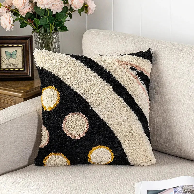 Black and cream fluffy tufted pillow cover with bold diagonal stripes and gold outlined circles for decorbites black abstract eye decor