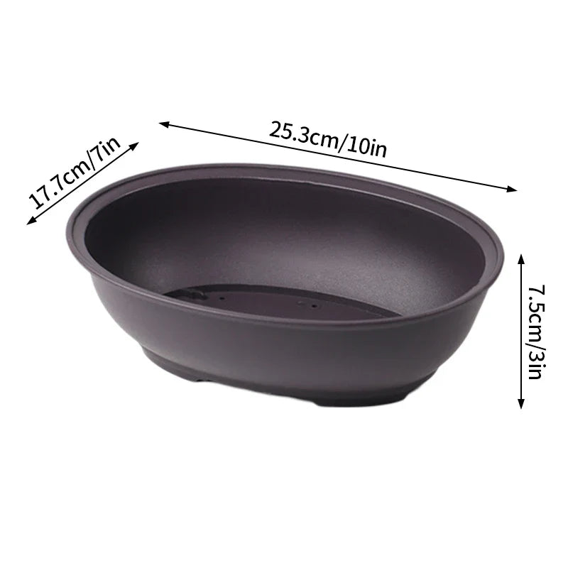 Dark gray oval ceramic plant pot with smooth matte finish and subtle footed base for para plantas or pot flowerpots