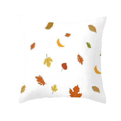 White throw pillow with plush fabric featuring a pattern of autumn maple leaves in orange yellow and brown for living room decor