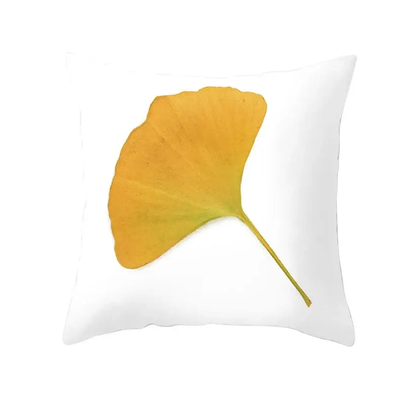 White throw pillow with golden-yellow ginkgo leaf print featuring autumn maple leaves for living room decor