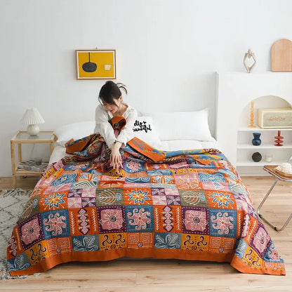 Vibrant botanical orange and blue cotton gauze blanket bedspread with intricate geometric and floral patterns for bedroom decorbites birds plaid