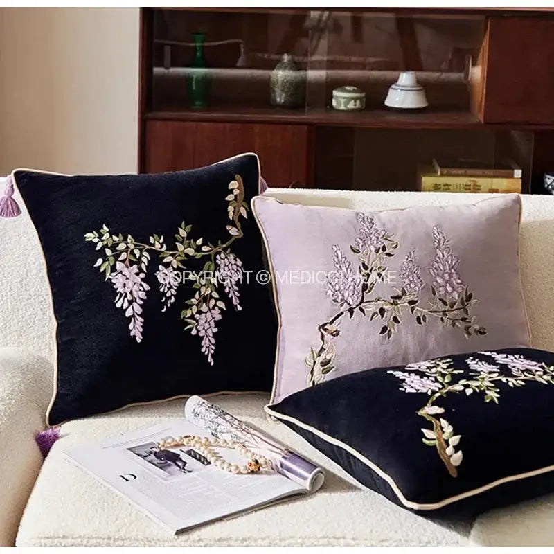 Two velvet throw pillows in black and light purple with botanical wisteria embroidered cushion cover decorbites design