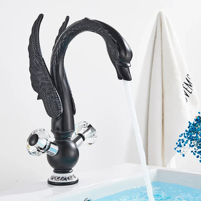Black swan-shaped antique brass basin faucet with crystal knobs and ornate detailing deck mounted design