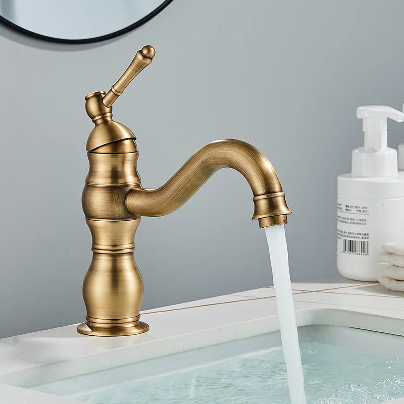 Antique brass-finished single-handle bathroom basin mixer faucet with curved spout and decorative ridged body