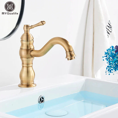 Antique brass-finished single-handle bathroom basin mixer faucet with curved spout and decorative ridged body