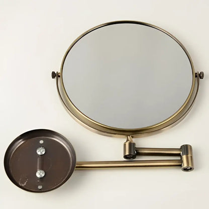 Brass bronze folding makeup mirror with circular magnifying glass and adjustable wall-mounted articulated arm by decorbites brass bronze