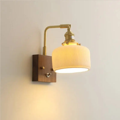Brass ceramic ball led wall light with yellow globe features ribbed off-white glass shade and wooden mounting plate wall light