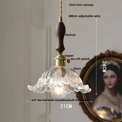 A delicate clear glass led pendant light with fluted petal design and dark walnut handle for dining room decorbites