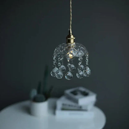 A delicate brass pendant light with clear glass led crystals and faceted beads for dining room decorbites decor