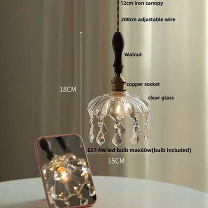 A delicate clear glass led pendant light with walnut iron canopy and teardrop crystals by decorbites