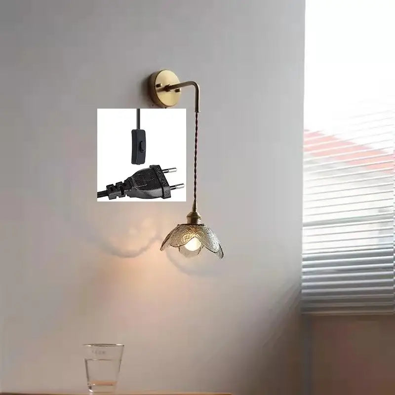 Antique brass wall lamp with a delicate petal-shaped gray glass led shade for bathroom use