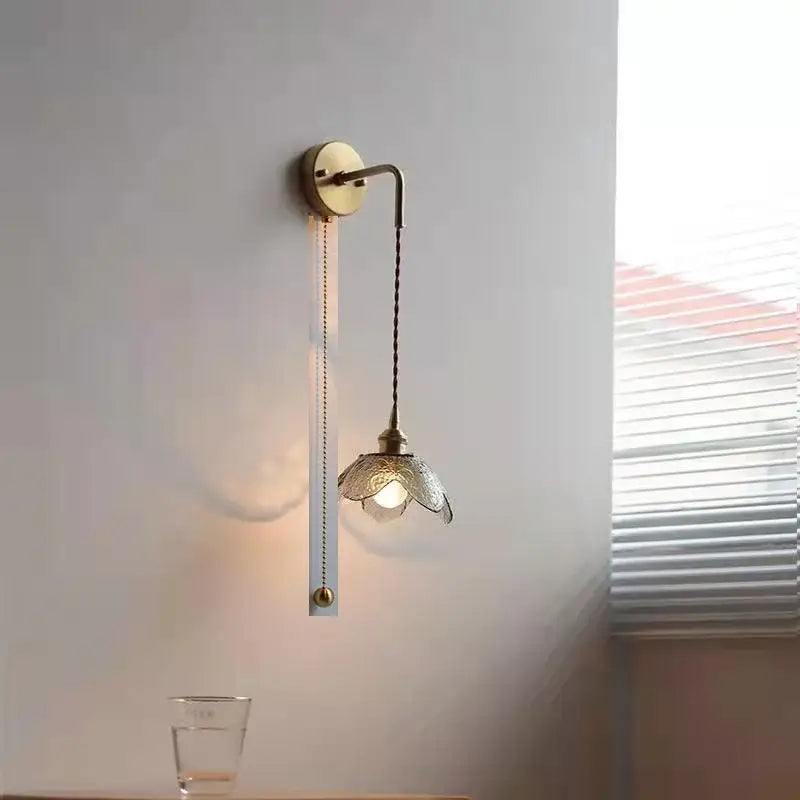 Antique brass wall lamp with gray glass led flower shade and elegant curved arm for glass led bathroom lighting