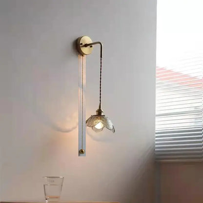 Antique brass wall lamp with gray glass led flower shade and elegant curved arm for glass led bathroom lighting