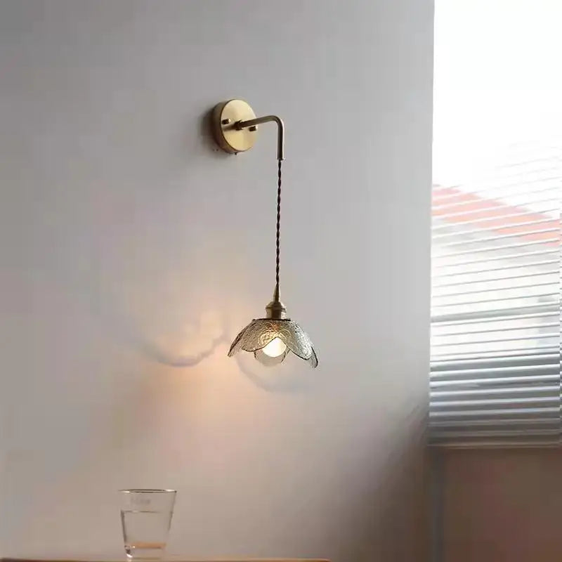 Antique brass wall lamp with a delicate gray glass led flower shade for bathroom use