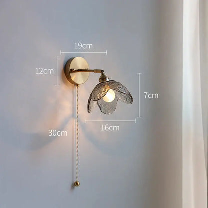 A brass flower gray glass led bathroom wall lamp with a textured translucent glass shade and adjustable pull chain wall lamp