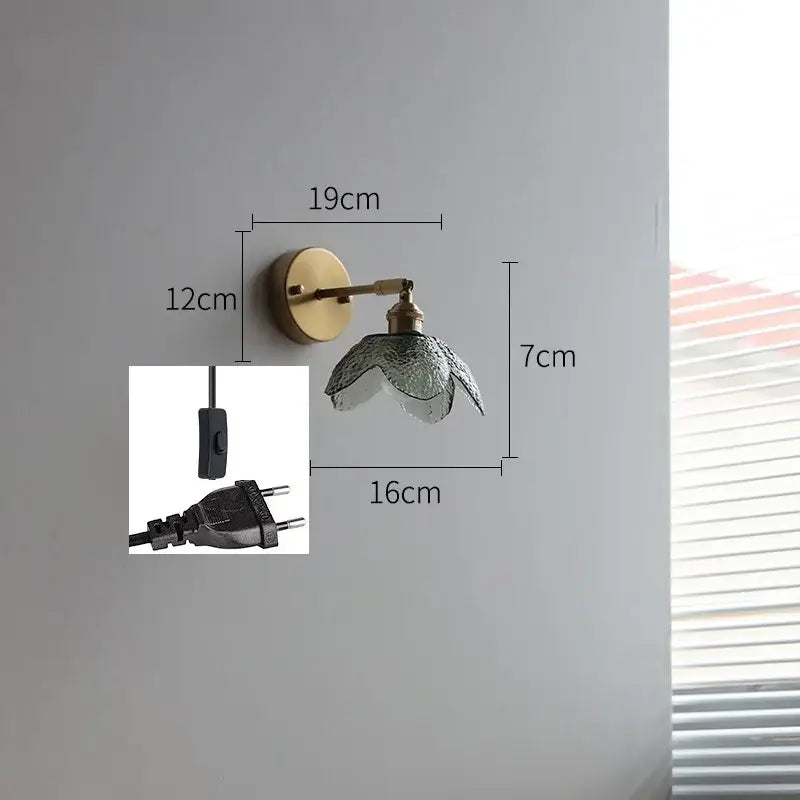 Brass flower gray glass led bathroom wall lamp with a textured translucent glass lampshade on a brass wall sconce