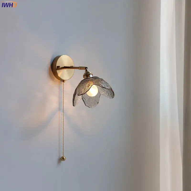 Brass flower gray glass led bathroom wall lamp with textured translucent gray glass shade shaped like open flower