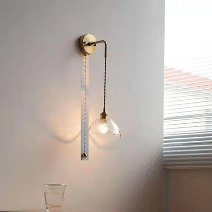 Brass flower gray glass led bathroom wall lamp with a slender curved arm and elegant blooming flower glass shade