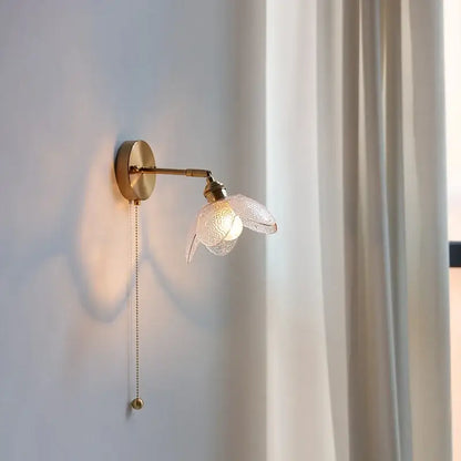 Brass flower gray glass led wall lamp with gold-toned adjustable arm and delicate translucent glass flower shade for bathroom